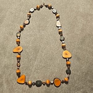 Long costume necklace with wood colored plastic beads